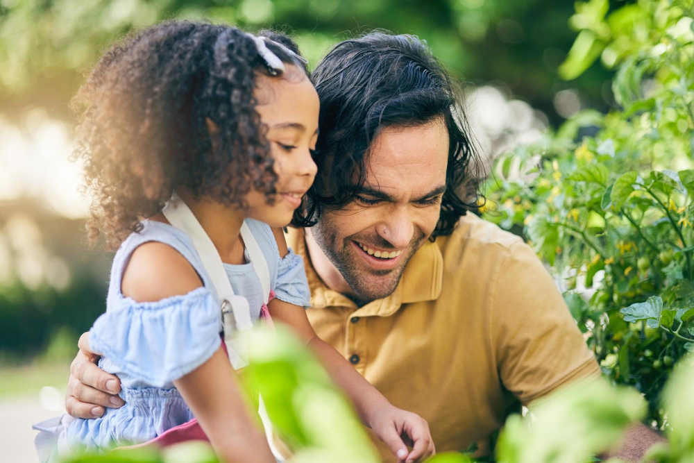 A dad and daughter looking at flowers in SPring